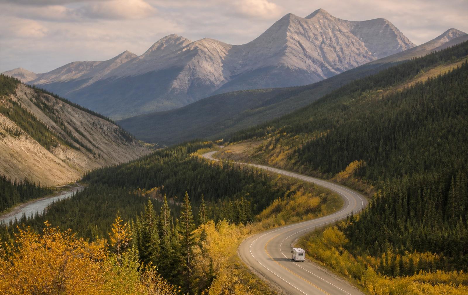 A motorhome winding through mountain roads